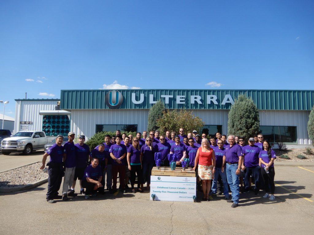 Ulterra Canada employees in front of an Ulterra building presenting a $25,000 check for Childhood Cancer Canada