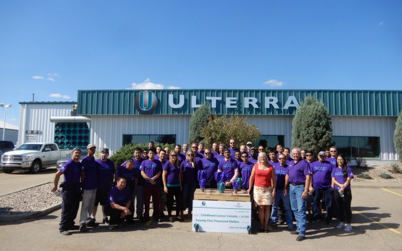 Ulterra Canada employees in front of an Ulterra building presenting a $25,000 check for Childhood Cancer Canada